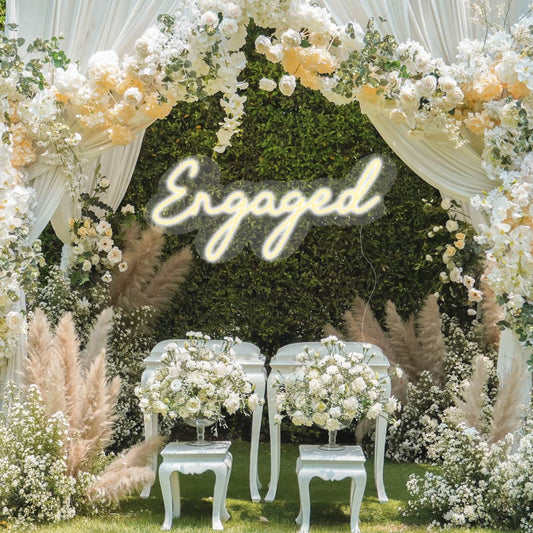 Engaged neon sign on a flower wall for a special wedding day sign