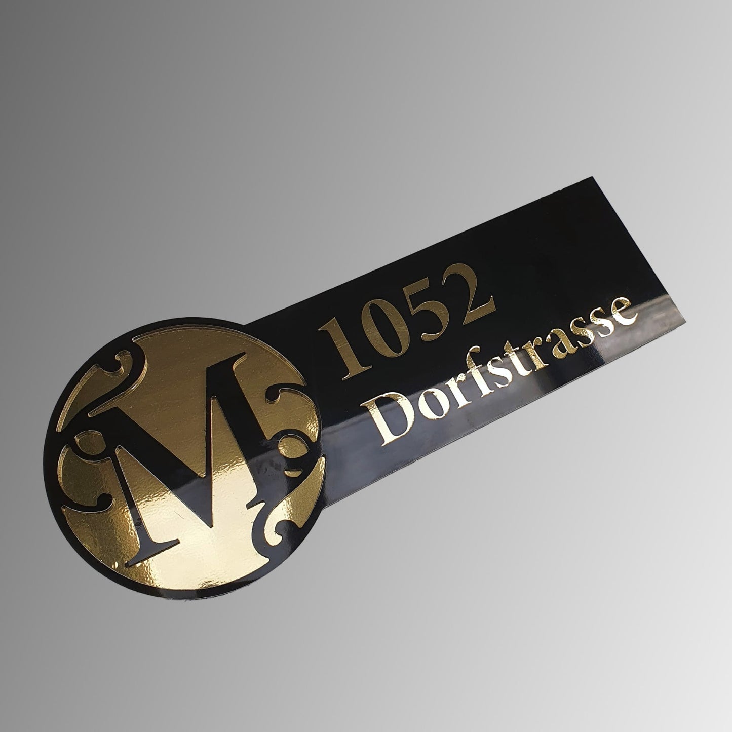 Side profile showing a door number with street name house plaque