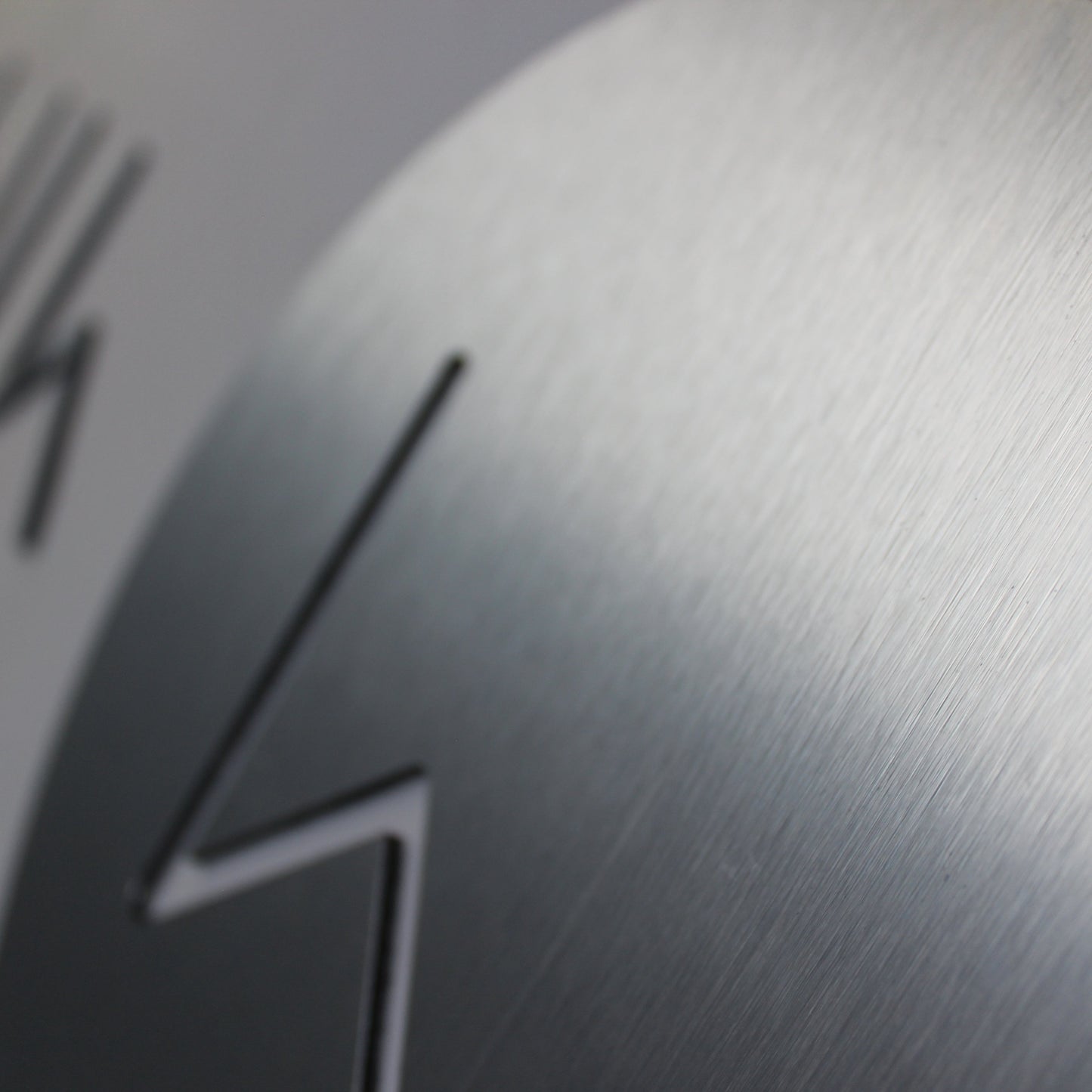 router cut logo in a brushed silver colour