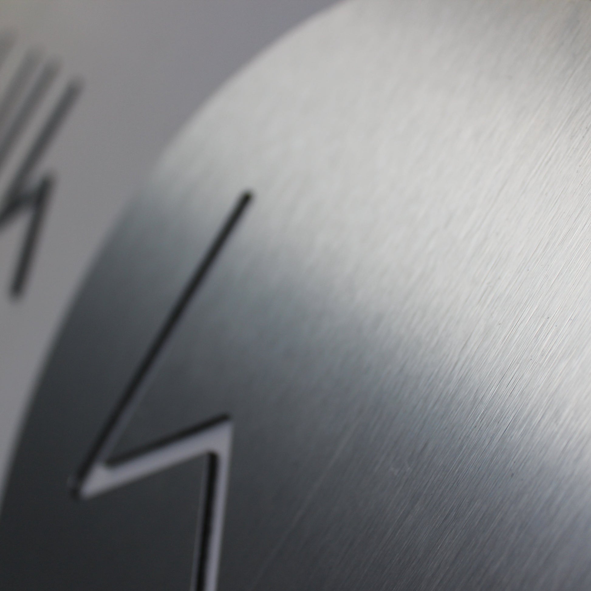 router cut logo in a brushed silver colour