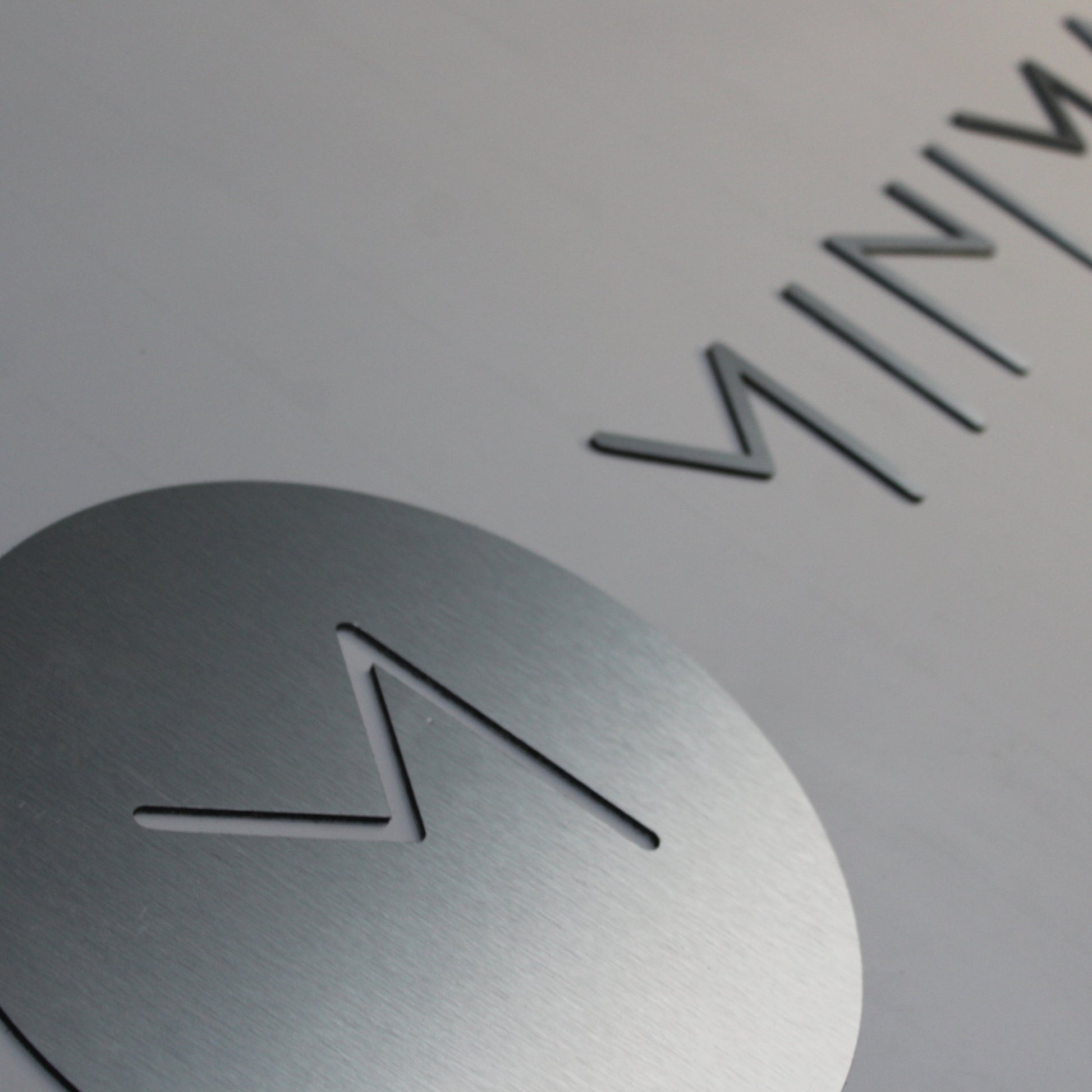 a brushed silver cut logo