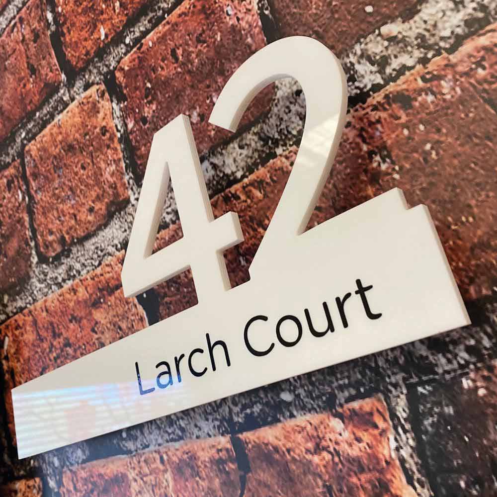 white number 42 door sign with black writing over