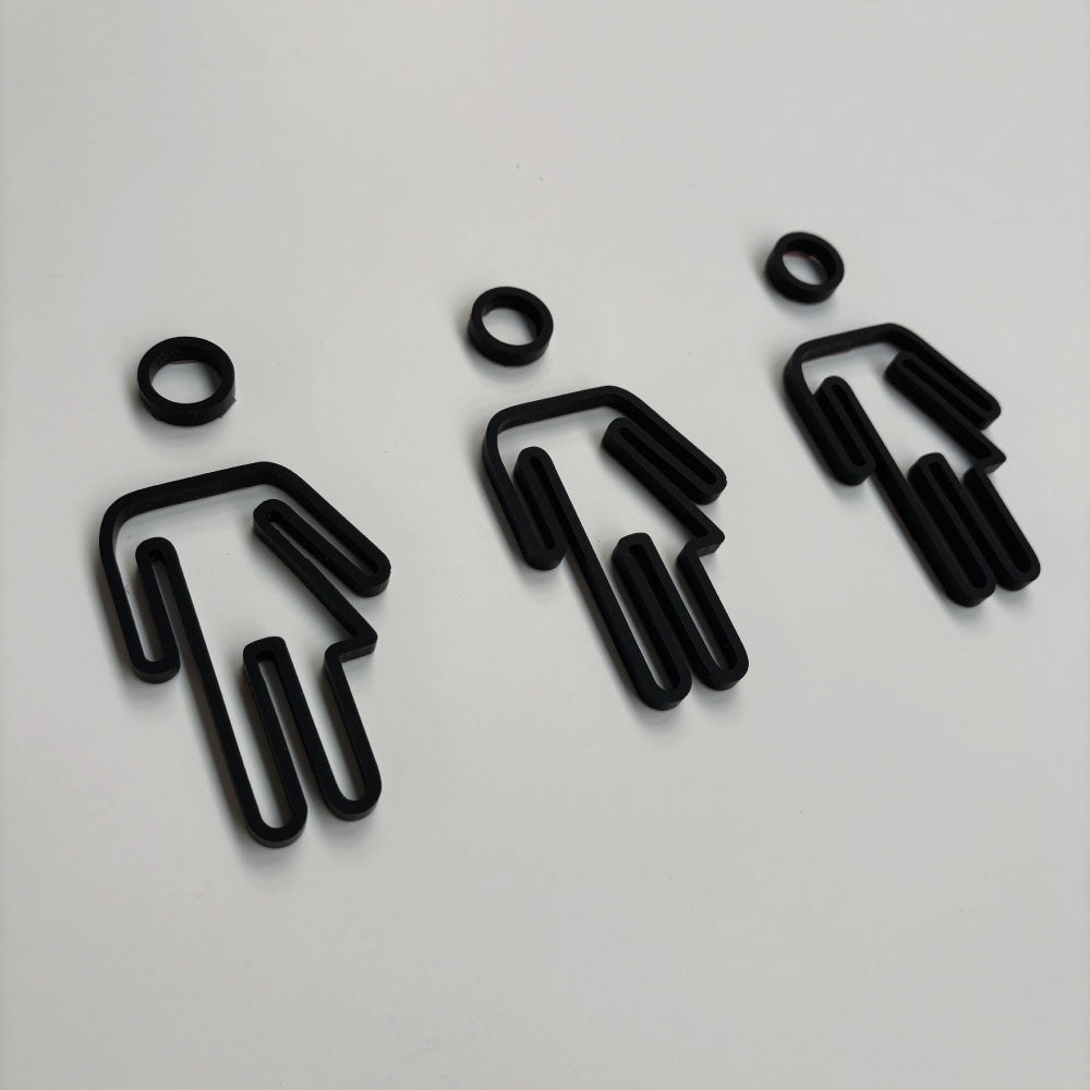 Gender neutral toilet door signs on a wwhite door showing a black acrylic icon of a gender neutral symbol