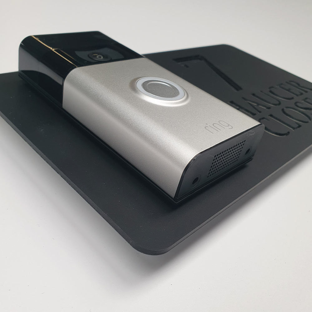 Black house sign with a video doorbell on showing text and street address in a black and silver finish side profile