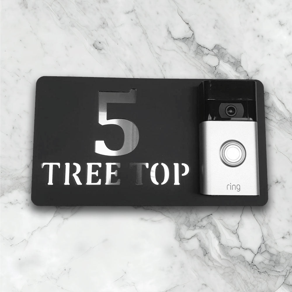 Black house sign with a video doorbell on showing text and street address in a black and silver finish face on