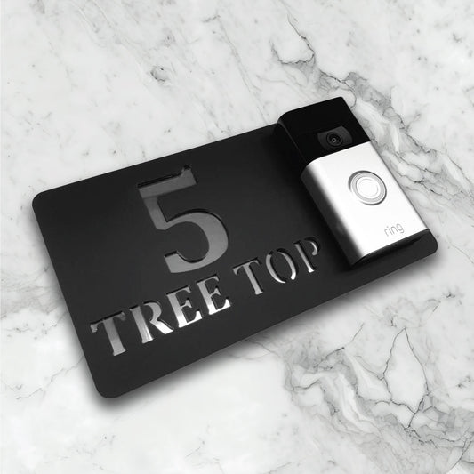 Black house sign with a video doorbell on showing text and street address in a black and silver finish