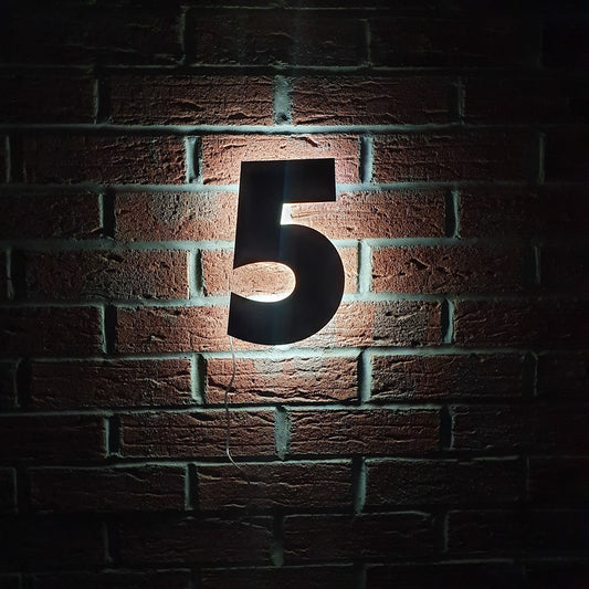 a number 5 in the dark showing illuminating door number