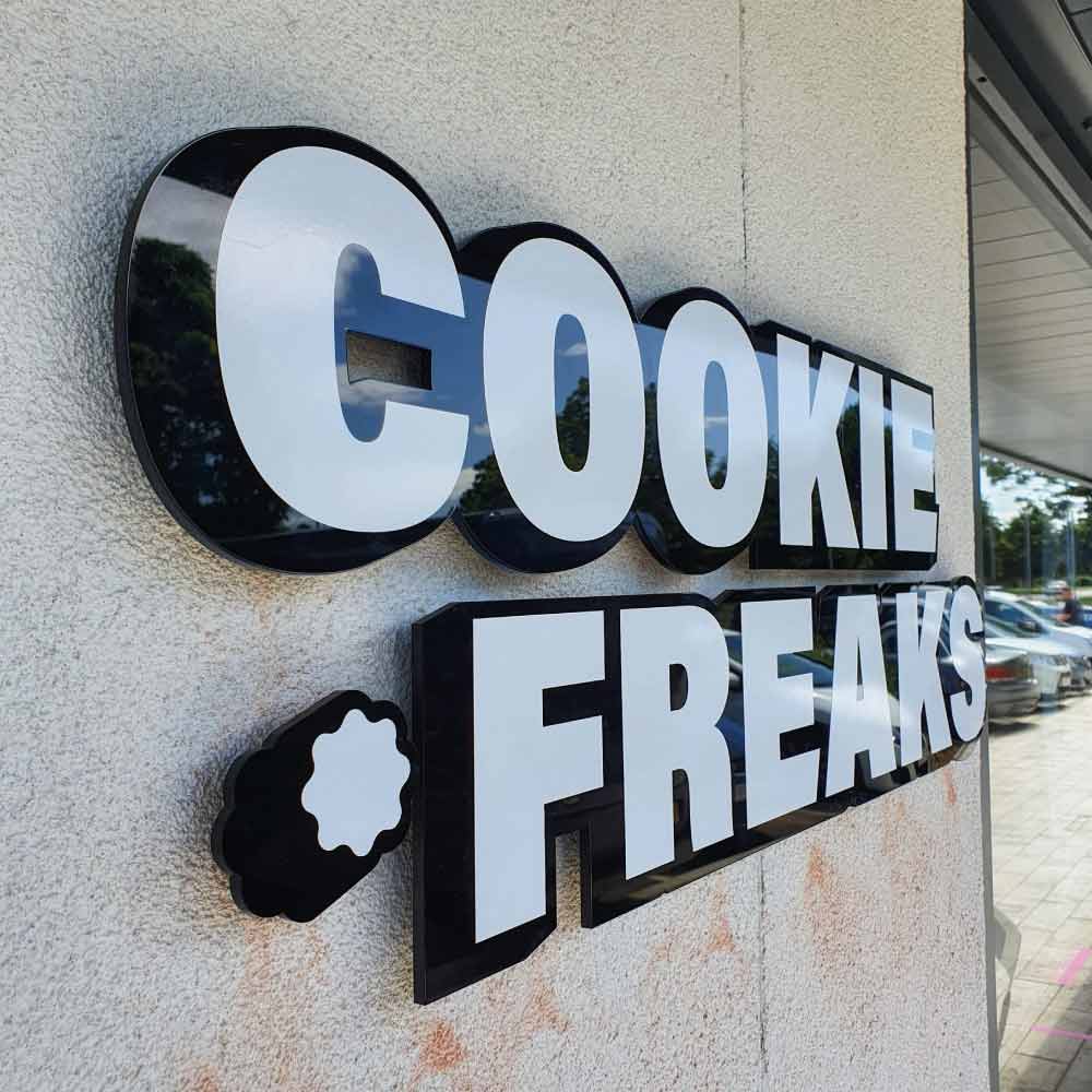 a external sign of a cookie shop in a 3d cut logo shape