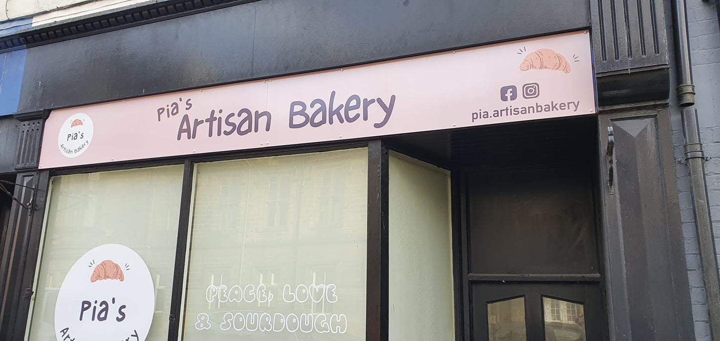 shop sign in pink drilled into the fascia