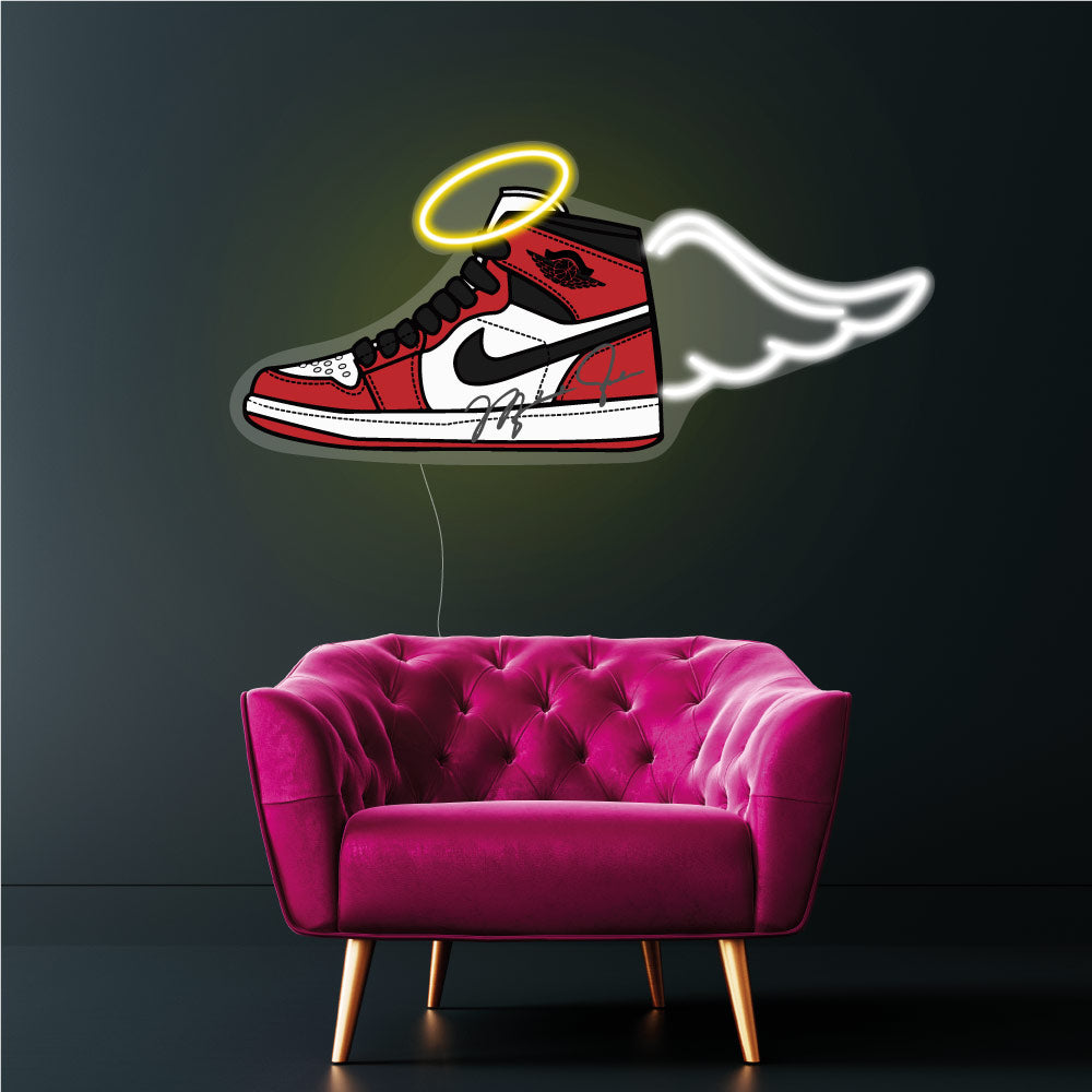 nike jordan sneaker neon sign above a pink chair
