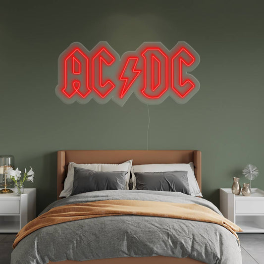 red acdc neon sign on a green wall