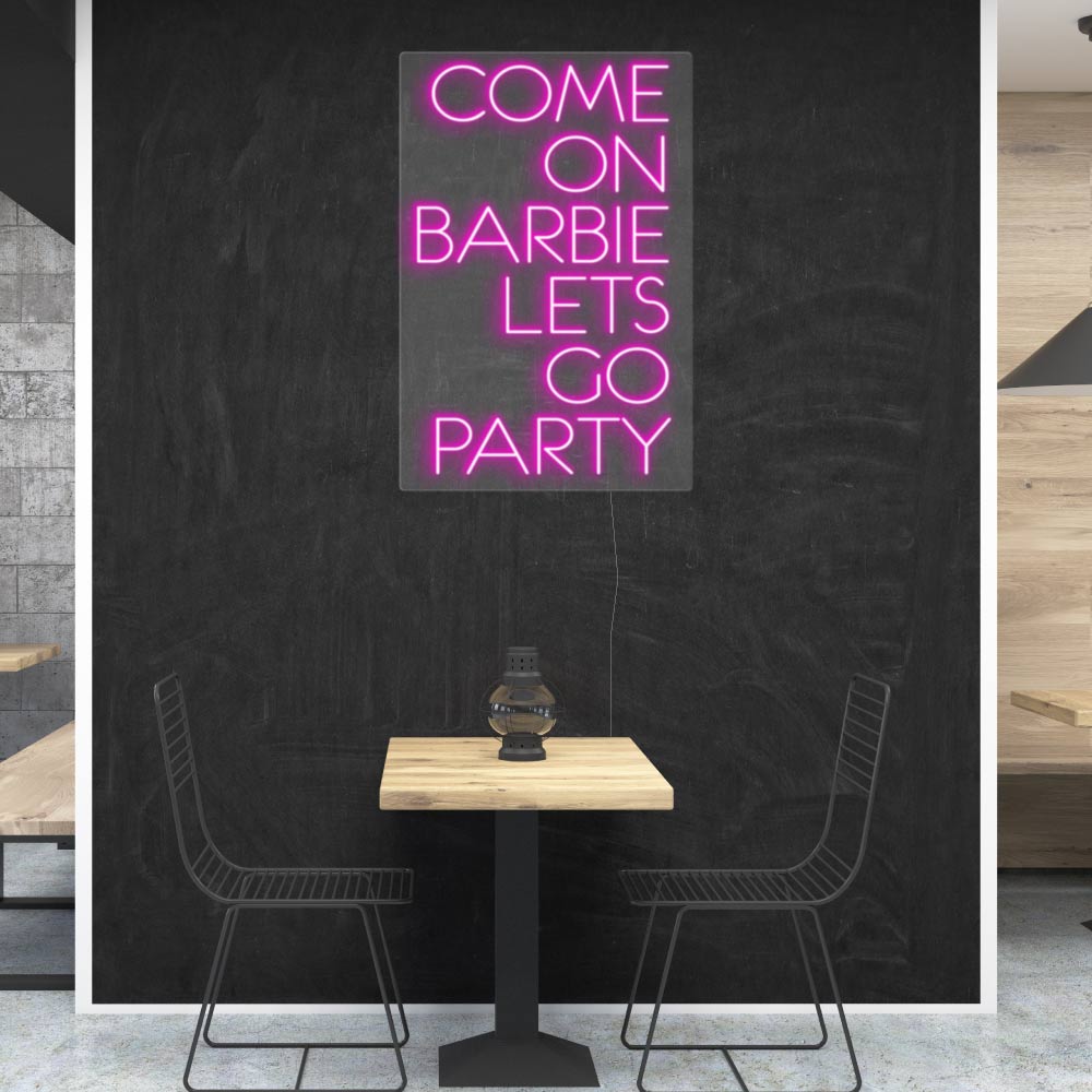 an acrylic sign saying come on barbie lets go party