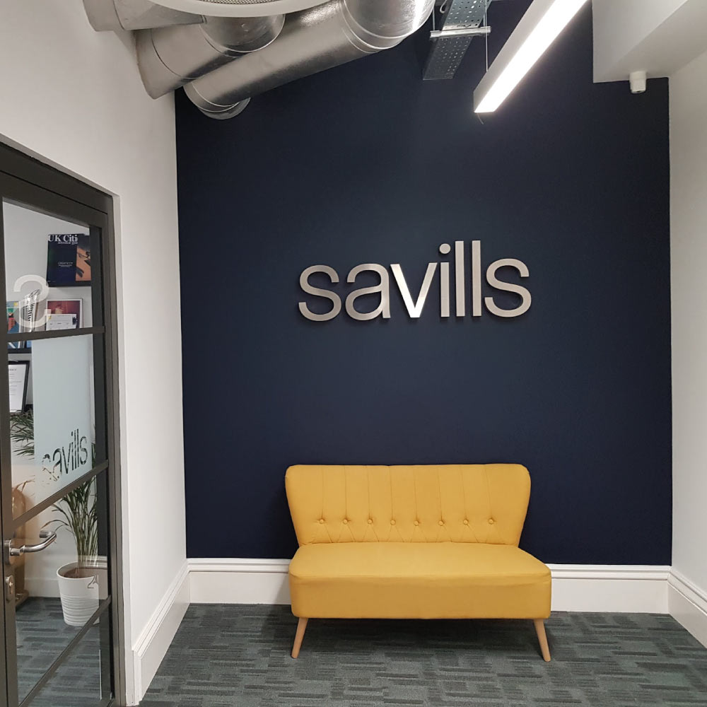 savills business logo on a wall in a office