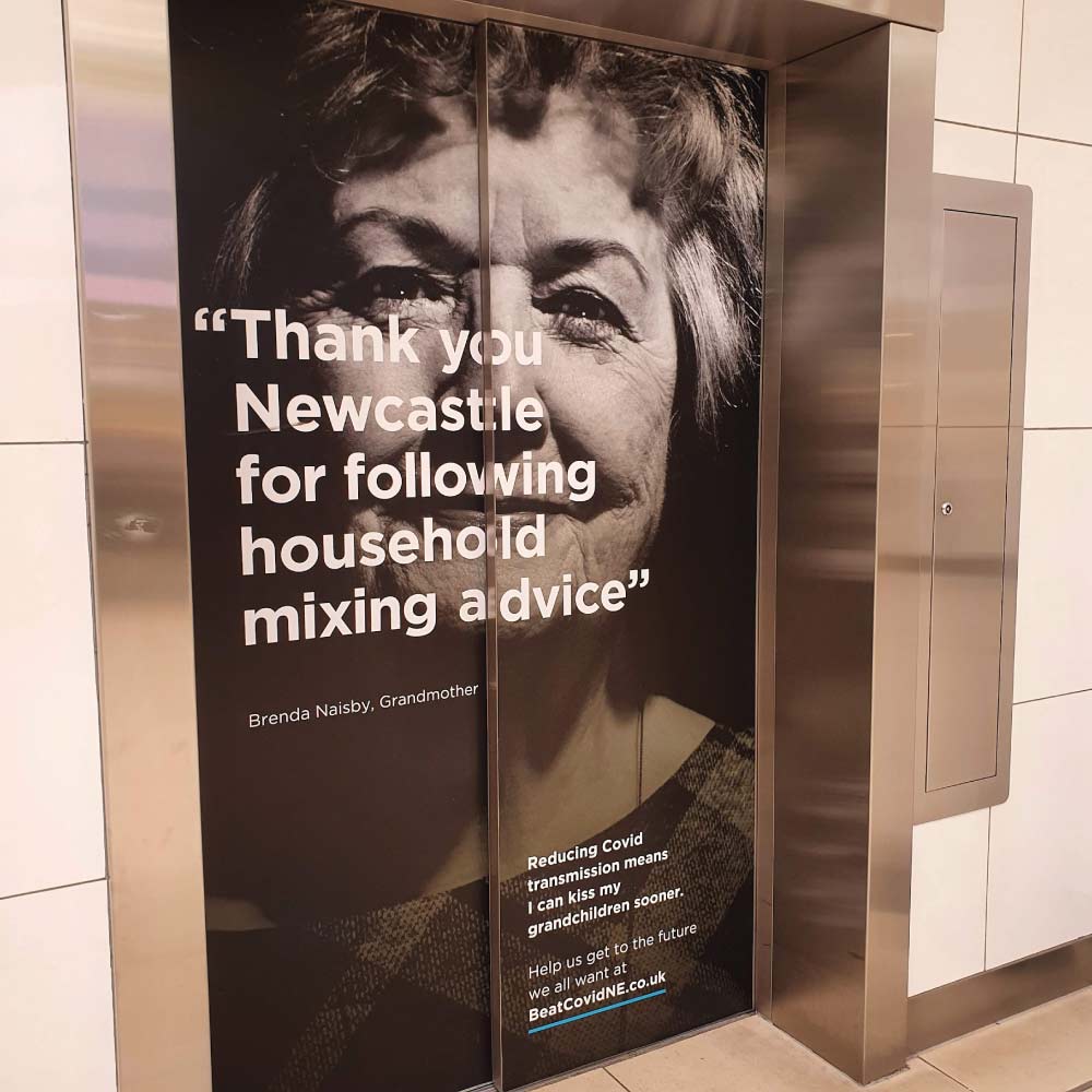 a lift covered in a vinyl print with a business branding 