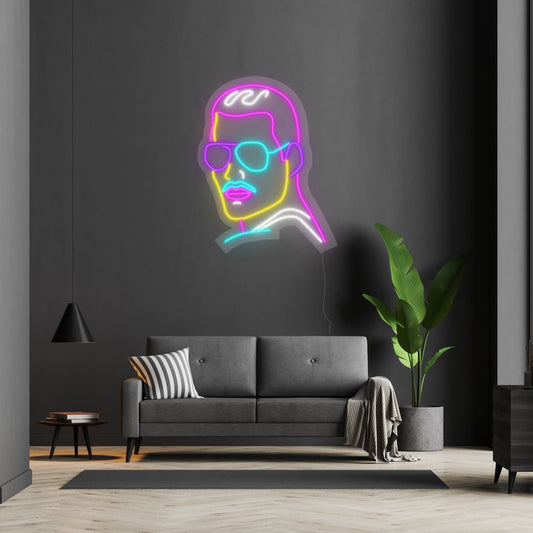 a neon of freddie mercury hanging above a sofa
