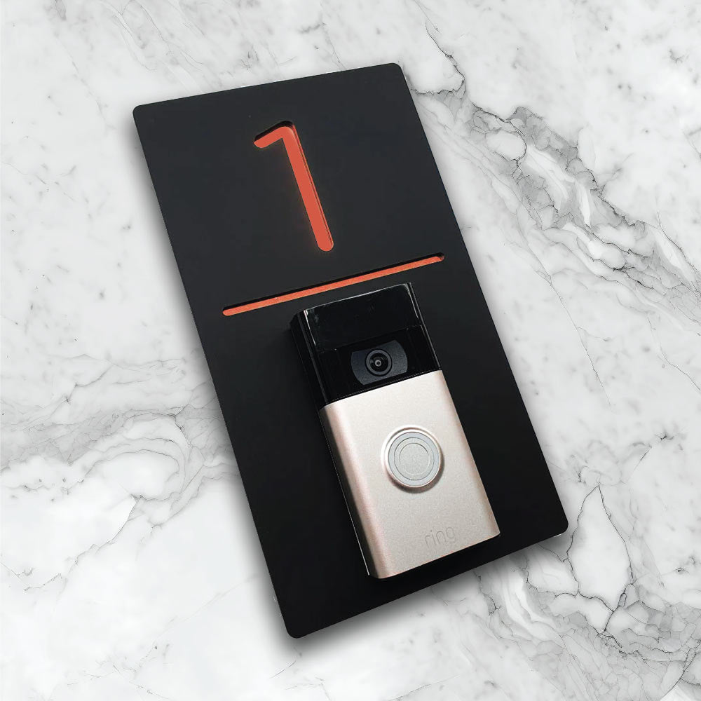 Black vertical house sign with Rose gold details with an added video ring doorbell on face of house plaque