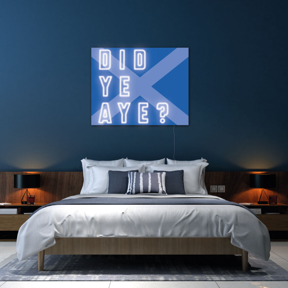 did ye aye neon sign above a bed with blue walls