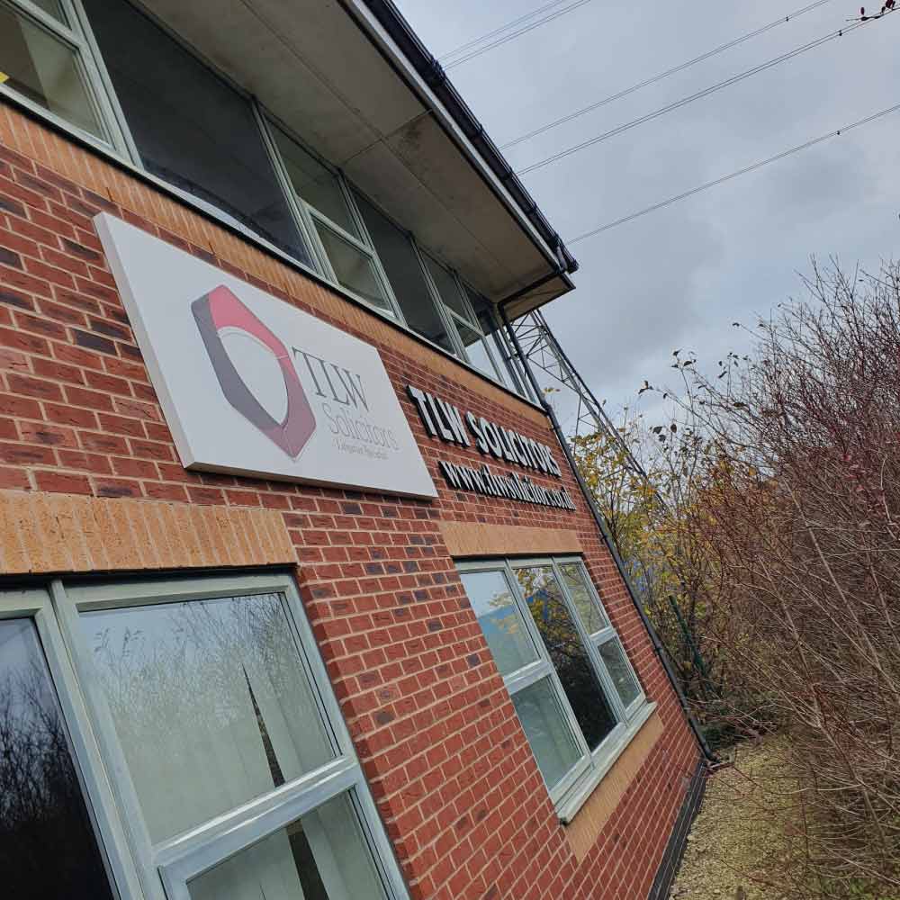 a solicitors outside sign with a metal folded tray system